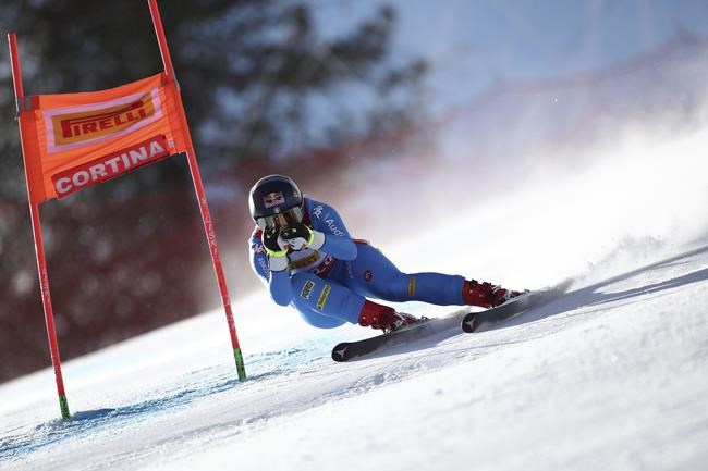 FILE - Italy's Sofia Goggia speeds down the course during an alpine ski, women's World Cup downhill, in Cortina d'Ampezzo, Italy, Jan. 22, 2022. Goggia, the reigning gold medalist in the women’s downhill, is hoping to compete in Beijing, even though she sprained her left knee and fractured a bone in her leg during a race in January. (AP Photo/Gabriele Facciotti, File)