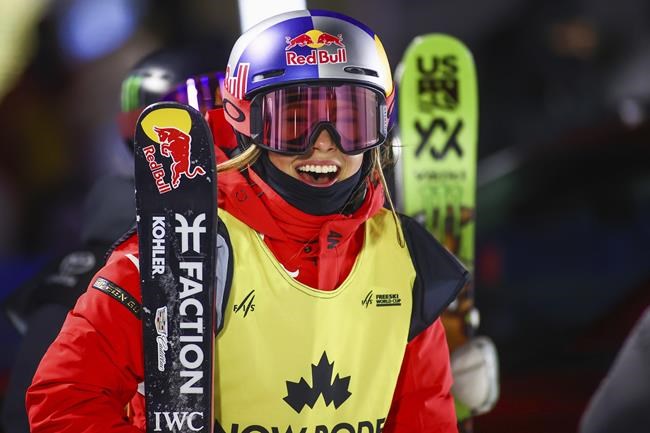 FILE - China's Eileen Gu smiles following her final run during the World Cup women's freestyle skiing halfpipe final Jan. 1, 2022, in Calgary, Alberta. American-born daredevil Gu will be trying to win gold medals for China at the Beijing Games. Gu's mother is from the host country and the 18-year-old freestyle skier made the decision to compete for China instead of the United States. (Evan Buhler/The Canadian Press via AP, File)