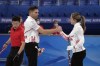 Canada's John Morris and Rachel Homan, shake hands after winning the mixed doubles curling match against China, at the 2022 Winter Olympics, Friday, Feb. 4, 2022, in Beijing. THE CANADIAN PRESS/AP/Nariman El-Mofty