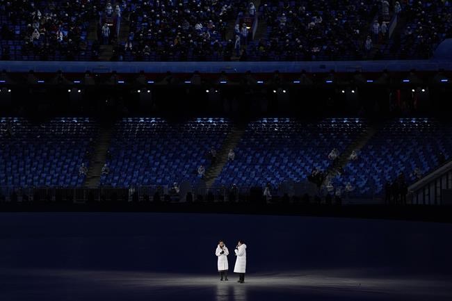 Hosts address the crowd during the pre-show ahead of the opening ceremony of the 2022 Winter Olympics, Friday, Feb. 4, 2022, in Beijing. (AP Photo/Jae C. Hong)