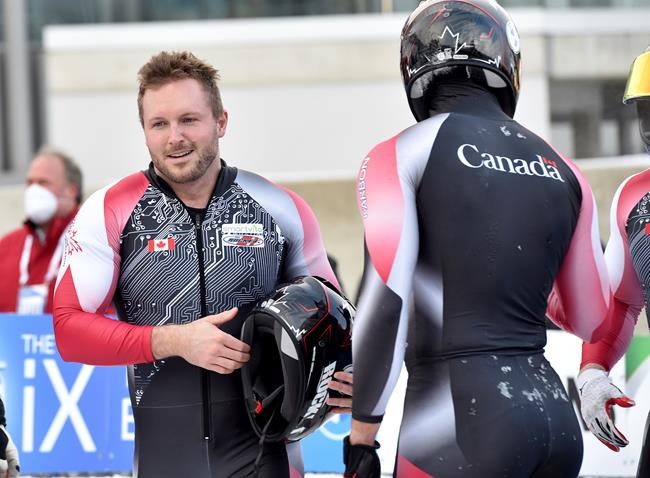 Canada's pilot Justin Kripps, left, takes third place with his team Ryan Sommer, Cam Stones and Benjamin Coakwell after the four-man bobsleigh world cuo race in Winterberg, Germany, Saturday, Dec. 11, 2021. THE CANADIAN PRESS/AP-Caroline Seidel/dpa via AP