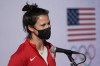 Speedskater Brittany Bowe answers questions before boarding a plane enroute to Beijing for the Olympics Olympics at a Delta Airlines terminal Thursday, Jan. 27, 2022, in Los Angeles. (AP Photo/Marcio Jose Sanchez)
