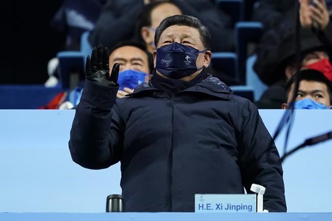 Chinese President Xi Jinping waves during the opening ceremony of the 2022 Winter Olympics, Friday, Feb. 4, 2022, in Beijing. (AP Photo/Jae C. Hong)