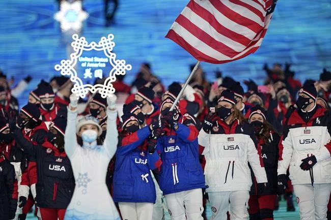 Brittany Bowe and John Shuster, of the United States, leads their team in during the opening ceremony of the 2022 Winter Olympics, Friday, Feb. 4, 2022, in Beijing. (AP Photo/David J. Phillip)