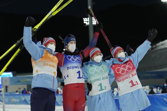 From left, Tarjei Boe of Norway, Johannes Thingnes Boe, Tiril Eckhoff and Marte Olsbu Roeiseland pose after their first place finish in the biathlon 4x6-kilometer mixed relay the 2022 Winter Olympics, Saturday, Feb. 5, 2022, in Zhangjiakou, China. (AP Photo/Kirsty Wigglesworth)