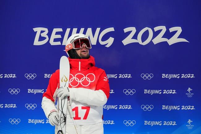 Quebec City's Laurent Dumais looks at the board after competing in the men's moguls at the 2022 Winter Olympics in Zhangjiakou, China on Saturday, February 5, 2022. Dumais placed 16th after scoring a 71.39 in the event's second qualifying round. THE CANADIAN PRESS/Sean Kilpatrick