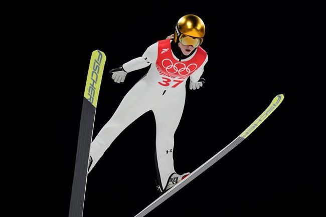 Nika Kriznar, of Slovenia, soars through the air during the women's normal hill individual ski jumping trial round at the 2022 Winter Olympics, Saturday, Feb. 5, 2022, in Zhangjiakou, China. (AP Photo/Andrew Medichini)