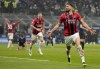 AC Milan's Olivier Giroud celebrates after scoring his side's opening goal during the Serie A soccer match between Inter Milan and AC Milan at the San Siro Stadium, in Milan, Italy, Saturday, Feb. 5, 2022. (AP Photo/Antonio Calanni)