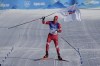 Russian athlete Alexander Bolshunov celebrates before winning the gold medal during the men's 15km + 15km skiathlon cross-country skiing competition at the 2022 Winter Olympics, Sunday, Feb. 6, 2022, in Zhangjiakou, China. (AP Photo/Alessandra Tarantino)
