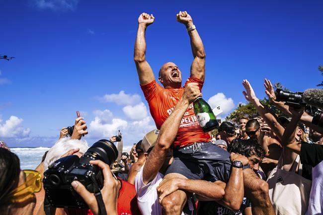 Kelly Slater celebrates after winning the Billabong Pro Pipeline on Feb. 5, 2022, in Haleiwa, Hawaii. Slater won the contest just short of his 50th birthday. (Brady Lawrence/World Surf League via AP)