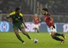 Egypt's Mohamed Salah, right, controls the ball as Senegal's Abdou Diallo defends during the African Cup of Nations 2022 final soccer match between Senegal and Egypt at the Ahmadou Ahidjo stadium in Yaounde, Cameroon, Sunday, Feb. 6, 2022. (AP Photo/Themba Hadebe)