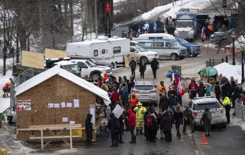 A wooden structure built by protesters is seen beside Confederation Park as a protest against COVID-19 restrictions that has been marked by gridlock and the sound of truck horns continues into its second week, in Ottawa, on Sunday, Feb. 6, 2022. THE CANADIAN PRESS/Justin Tang