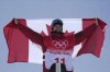 Gold medalist Canada's Max Parrot celebrates during the award ceremony for the men's slopestyle at the 2022 Winter Olympics, Monday, Feb. 7, 2022, in Zhangjiakou, China. (AP Photo/Gregory Bull)