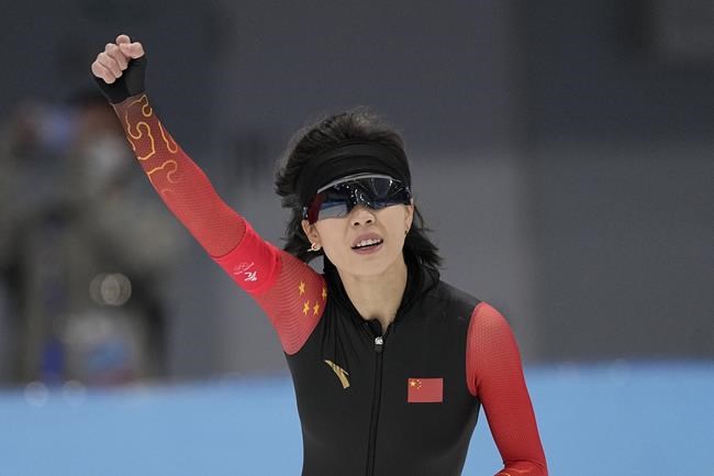 Ahenaer Adake of China reacts after finishing her heat in the women's speedskating 1,500-meter race at the 2022 Winter Olympics, Monday, Feb. 7, 2022, in Beijing. (AP Photo/Sue Ogrocki)