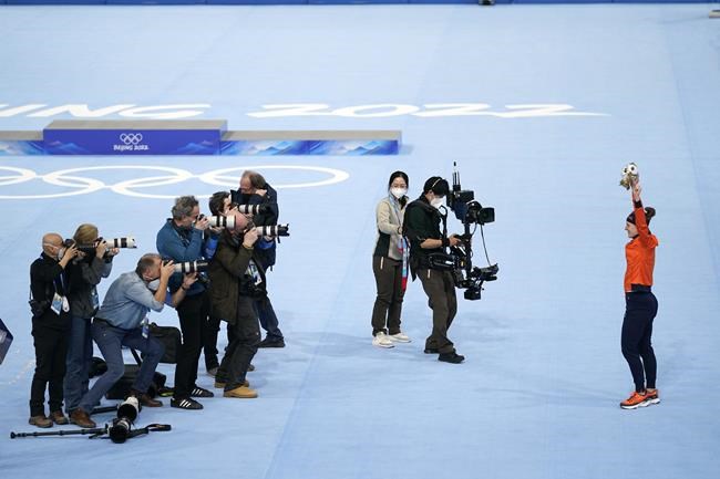 Ireen Wust of the Netherlands reacts during a flower ceremony after winning the gold medal and setting an Olympic record in the women's speedskating 1,500-meter race at the 2022 Winter Olympics, Monday, Feb. 7, 2022, in Beijing. (AP Photo/Ashley Landis)