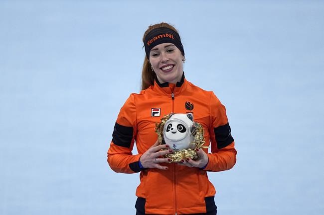Antoinette de Jong of the Netherlands reacts during a flower ceremony after winning the bronze medal in the women's speedskating 1,500-meter race at the 2022 Winter Olympics, Monday, Feb. 7, 2022, in Beijing. (AP Photo/Ashley Landis)