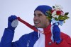 Johan Clarey, of France, silver, reacts during the medal ceremony for the men's downhill at the 2022 Winter Olympics, Monday, Feb. 7, 2022, in the Yanqing district of Beijing. (AP Photo/Luca Bruno)