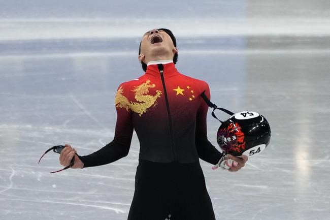 Ren Ziwei of China, celebrates after winning the men's 1,000-meter final during the short track speedskating competition at the 2022 Winter Olympics, Monday, Feb. 7, 2022, in Beijing. (AP Photo/Natacha Pisarenko)