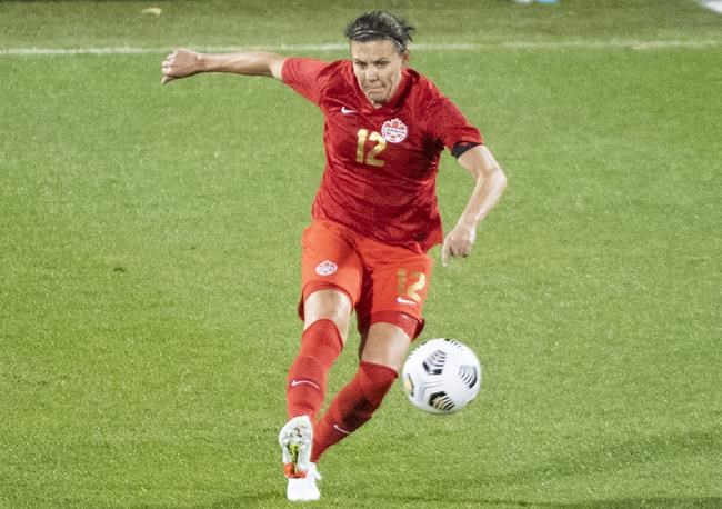 Canada’s Christine Sinclair plays a pass during first half Celebration Tour soccer action against New Zealand in Montreal, Tuesday, October 26, 2021. THE CANADIAN PRESS/Graham Hughes