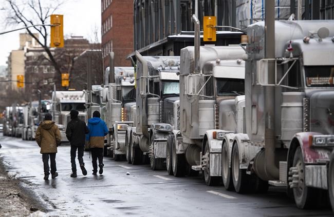 Trucks are parked on Metcalfe Street as a rally against COVID-19 restrictions in Ottawa, on Sunday, Jan. 30, 2022. Ontario Superior Court Justice Hugh McLean has granted a10-day injunction to prevent truckers parked on city streets in downtown Ottawafrom honking their horns incessantly. THE CANADIAN PRESS/Justin Tang
