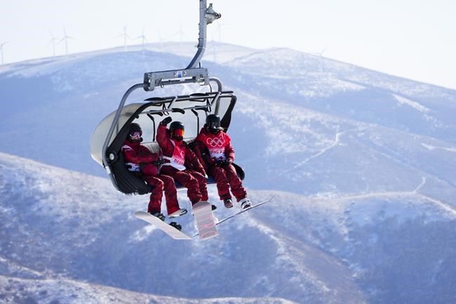 Canadian snowboarder’s Brooke Voigt, of Fort McMurray, Alta., left to right, Laurie Blouin of Quebec City, Que., and Jasmine Baird of Georgetown, Ont., ride the chair-lift as they train on the slopestyle course at the Genting Snow Park prior to the start of the Beijing Winter Olympics in Zhangjiakou, China, on Thursday, Feb. 3, 2022. THE CANADIAN PRESS/Sean Kilpatrick