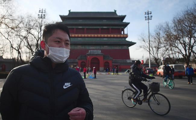 Jia Pei, 30, speaks during an interview about air quality next to the Drum Tower in Beijing on Monday, Feb. 7, 2021. He said the air in Beijing used to feel like