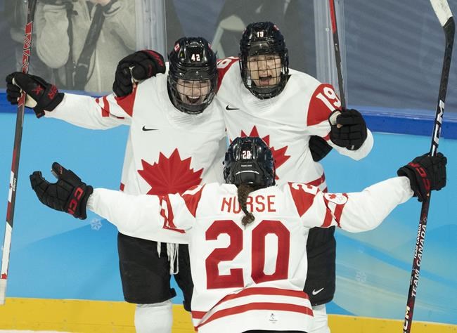 Canada forward Brianne Jenner (19) celebrates with teammates Claire Thompson (42) and Sarah Nurse (20) after scoring her second goal during second period women's ice hockey action against the United States at the 2022 Olympic Winter Games, in Beijing, Tuesday, Feb. 8, 2022. Brianne Jenner scored twice and captain Marie-Philip Poulin scored on a penalty shot for Canada in a 4-2 win over the United States in Olympic women's hockey Tuesday. THE CANADIAN PRESS/Ryan Remiorz