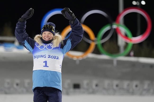 Jonna Sundling, of Sweden, celebrates during a venue ceremony after winning the gold medal in the women's sprint free cross-country skiing competition at the 2022 Winter Olympics, Tuesday, Feb. 8, 2022, in Zhangjiakou, China. (AP Photo/Alessandra Tarantino)