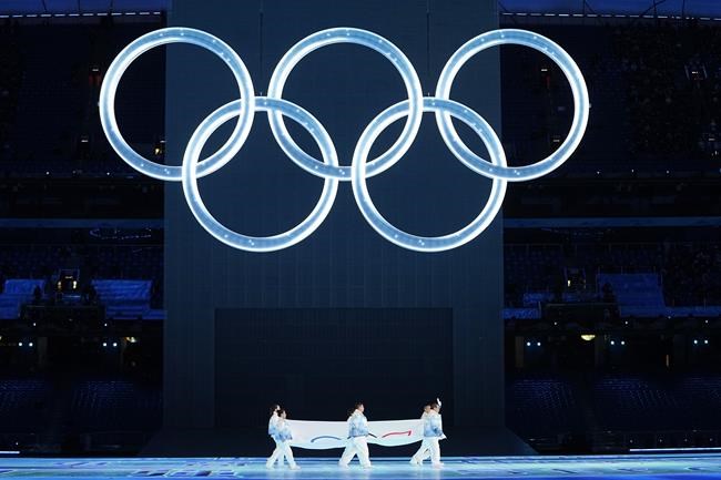 FILE - The Olympic flag is carried into the stadium during the opening ceremony of the 2022 Winter Olympics, Feb. 4, 2022, in Beijing. (AP Photo/Jae C. Hong, File)