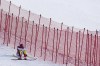 Mikaela Shiffrin, of the United States sits on the side of the course after skiing out in the first run of the women's slalom at the 2022 Winter Olympics, Wednesday, Feb. 9, 2022, in the Yanqing district of Beijing. (AP Photo/Robert F. Bukaty)
