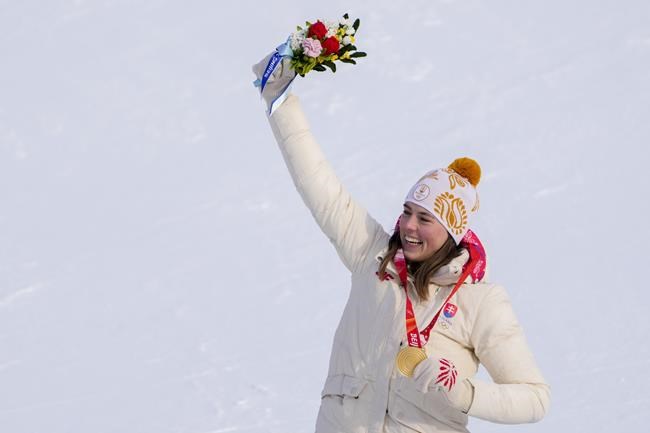 Petra Vlhova, of Slovakia, celebrates winning the gold medal in the women's slalom at the 2022 Winter Olympics, Wednesday, Feb. 9, 2022, in the Yanqing district of Beijing.(AP Photo/Pavel Golovkin)