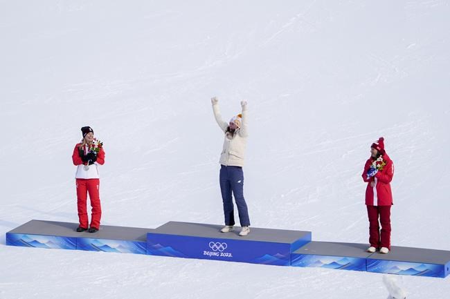 From left, Katharina Liensberger, of Austria, Petra Vlhova, of Slovakia, and Wendy Holdener, of Switzerland, celebrate at the podium for the women's slalom at the 2022 Winter Olympics, Wednesday, Feb. 9, 2022, in the Yanqing district of Beijing.(AP Photo/Pavel Golovkin)