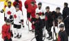 Team Canada head coach Jeremy Colliton, bottom centre, directs a team practice at the 2022 Winter Olympics in Beijing on Saturday, February 5, 2022. THE CANADIAN PRESS/Paul Chiasson
