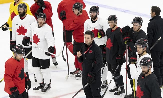 Team Canada head coach Jeremy Colliton, bottom centre, directs a team practice at the 2022 Winter Olympics in Beijing on Saturday, February 5, 2022. THE CANADIAN PRESS/Paul Chiasson