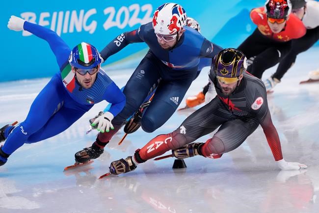 Canada's Charles Hamelin (right) slips during the men's 1,500-metre short-track speedskating semifinal at the Beijing Winter Olympics in Beijing, China, on Wednesday, Feb. 9, 2022. THE CANADIAN PRESS/Paul Chiasson