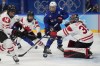 Canada goaltender Ann-Renee Desbiens (35) blocks a shot as United States' Hilary Knight (21) watches for a rebound during a preliminary round women's hockey game at the 2022 Winter Olympics, Tuesday, Feb. 8, 2022, in Beijing. THE CANADIAN PRESS/AP/Petr David Josek