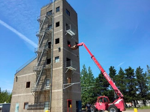 FILE - Portland Fire Department training recruits use a forklift to hoist dummies to the top of a six-story tower for a simulated rescue for tsunami and earthquake drill in Oregon and Washington state in Portland, Ore., June 7, 2016. More than 90% of Oregon’s liquid fuels are stored at a facility next to the Willamette River in Portland. Oregon lawmakers began taking steps to compel the owners and operators of aging storage tanks at the facility to make them earthquake resistant. (AP Photo/Gillian Flaccus, file)