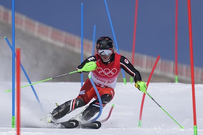 James Crawford, of Canada passes a gate during the slalom part of the men's combined at the 2022 Winter Olympics, Thursday, Feb. 10, 2022, in the Yanqing district of Beijing. (AP Photo/Robert F. Bukaty)