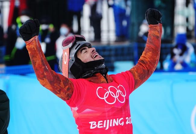 Canada's Eliot Grondin celebrates his silver medal in the men's snowboard cross final at the 2022 Beijing Winter Olympics in Zhangjiakou, China on Thursday, February 10, 2022. THE CANADIAN PRESS/Sean Kilpatrick