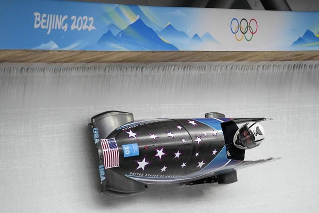 Elanta Meyers Taylor, of the United States, drives her bobsled during a women's monobob training heat at the 2022 Winter Olympics, Thursday, Feb. 10, 2022, in the Yanqing district of Beijing. (AP Photo/Mark Schiefelbein)