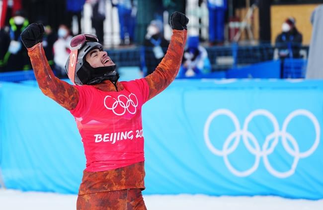 Canada's Eliot Grondin celebrates his silver medal in the men's snowboard cross final at the 2022 Beijing Winter Olympics in Zhangjiakou, China on Thursday, February 10, 2022. THE CANADIAN PRESS/Sean Kilpatrick