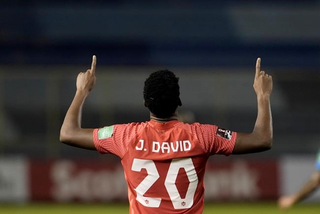 Canada's Jonathan David celebrates scoring his side's 2nd goal against El Salvador during a qualifying soccer match for the FIFA World Cup Qatar 2022 at Cuscatlan stadium in San Salvador, El Salvador, Wednesday, Feb. 2, 2022. THE CANADIAN PRESS/AP/Moises Castillo