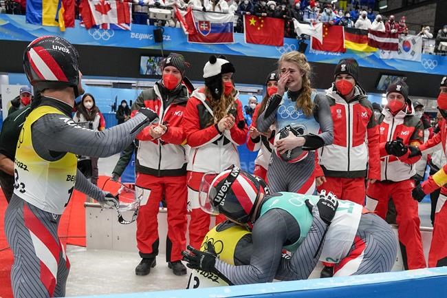 Madeleine Egle, Wolfgang Kindl, Thomas Steu and Lorenz Koller, of the Austria, celebrate winning the silver medal in the luge team relay the 2022 Winter Olympics, Thursday, Feb. 10, 2022, in the Yanqing district of Beijing. (AP Photo/Pavel Golovkin)