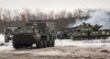 Ukrainian armored vehicles drive during military drills close to Kharkiv, Ukraine, Thursday, Feb. 10, 2022. Britain's envoy to Canada says the two countries are cooperating on a tough new set of sanctions against Russia if it invades Ukraine. (AP Photo/Andrew Marienko)