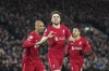 Liverpool's Diogo Jota, center, celebrates with his teammate Fabinho, left, after scoring his side's opening goal during the English Premier League soccer match between Liverpool and Leicester City at Anfield stadium in Liverpool, England, Thursday, Feb. 10, 2022. (AP Photo/Jon Super)