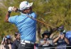 Hideki Matsuyama watches his drive on the ninth hole during the Phoenix Open golf tournament Thursday, Feb. 10, 2022, in Scottsdale, Ariz. (AP Photo/Darryl Webb)