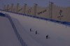 FILE - Workers prepare the halfpipe course at Genting Snow Park before the women's halfpipe finals at the 2022 Winter Olympics, Feb. 10, 2022, in Zhangjiakou, China. (AP Photo/Kiichiro Sato, File)