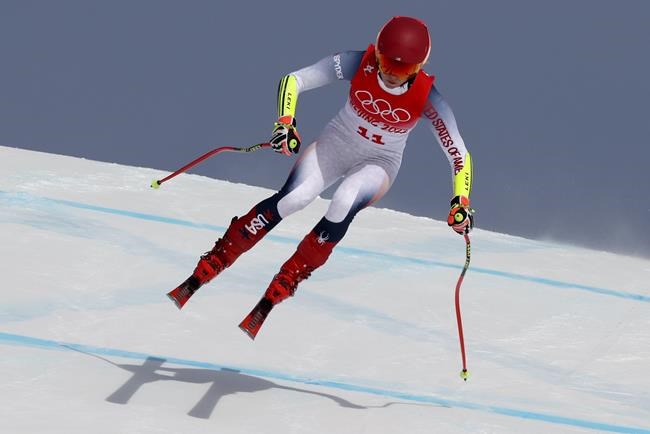 Mikaela Shiffrin, of United States makes a jump during the women's super-G at the 2022 Winter Olympics, Friday, Feb. 11, 2022, in the Yanqing district of Beijing. (AP Photo/Alessandro Trovati)