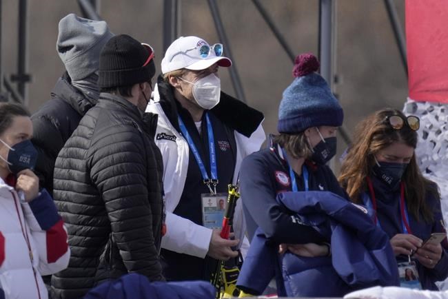 Norway's Aleksander Aamodt Kilde stands in the finish area to watch the the women's super-G where his girlfriend Mikaela Shiffrin, of United States is competing at the 2022 Winter Olympics, Friday, Feb. 11, 2022, in the Yanqing district of Beijing. (AP Photo/Luca Bruno)
