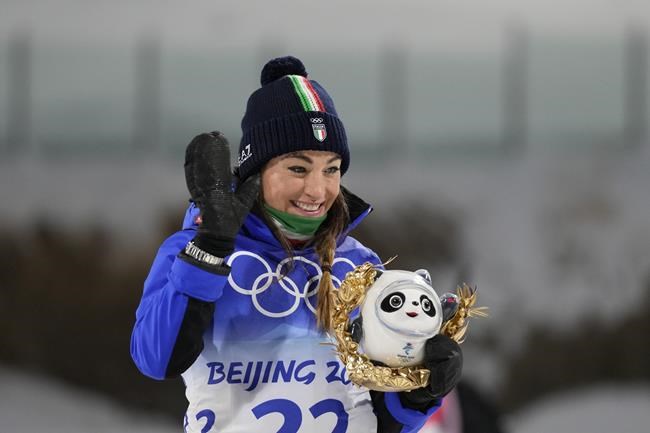 Dorothea Wierer of Italy celebrates during a venue ceremony after the women's 7.5-kilometer sprint competition at the 2022 Winter Olympics, Friday, Feb. 11, 2022, in Zhangjiakou, China. (AP Photo/Frank Augstein)
